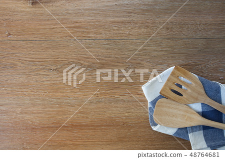 Wooden kitchen utensils and linen kitchen towels Wooden kitchen utensils and linen kitchen towels 48764681