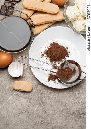 Ingredients for cooking tiramisu - Savoiardi biscuit cookies, mascarpone, cream, sugar, cocoa Ingredients for cooking tiramisu - Savoiardi biscuit cookies, mascarpone, cream, sugar, cocoa 48765658