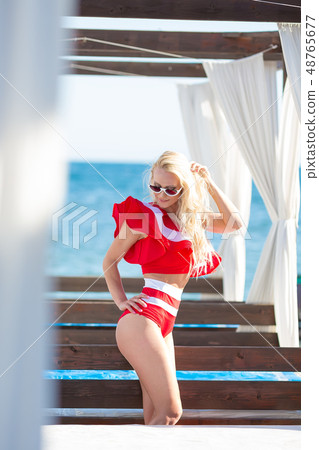 Sexy bikini body woman sun tanning relaxing Sexy bikini body woman sun tanning relaxing 48765677