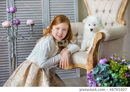Portrait of ginger hair girl play with husky poppy 48765807