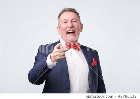 Mature man in blue suit pointing finger  48766132