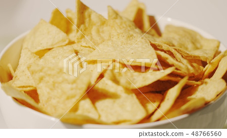 Pile of tortilla chips on the plate, close-up shot Pile of tortilla chips on the plate, close-up shot 48766560