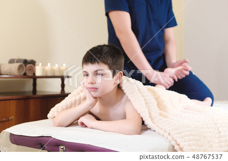 Little boy patient at reception at a professional masseuse. Foot Massage Therapy 48767537