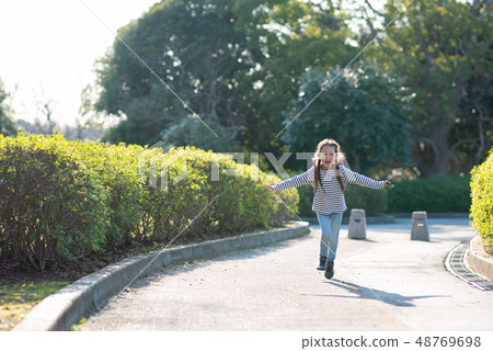 Girls carrying a school bag Girls carrying a school bag 48769698