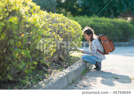 Girls carrying a school bag 48769699