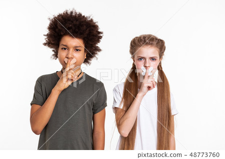 Serious resolute children posing with taped mouths Serious resolute children posing with taped mouths 48773760