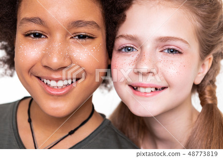 Pleasant good-looking kids displaying their strong white teeth 48773819