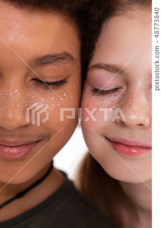 Pleasant cute children closing their eyes and showing faces 48773840