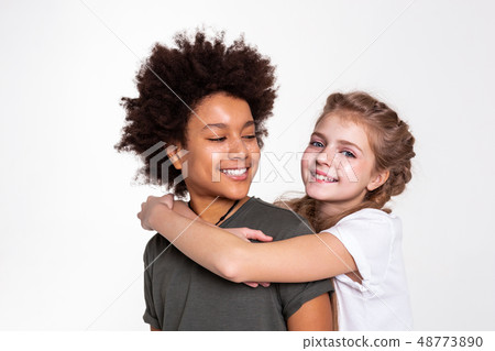 Pleasant dark-haired boy with wild hairstyle looking on his girlfriend Pleasant dark-haired boy with wild hairstyle looking on his girlfriend 48773890