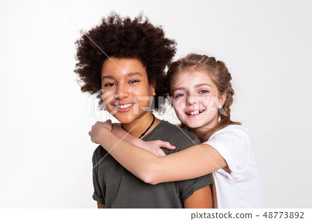 Contented good-looking kids spending time together in studio 48773892