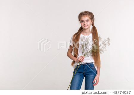Skinny pretty girl with long light hair wearing blue jeans Skinny pretty girl with long light hair wearing blue jeans 48774027