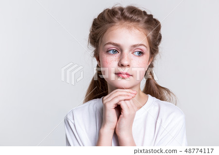 Thoughtful little lady with bright freckles looking aside Thoughtful little lady with bright freckles looking aside 48774117