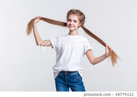 Cheerful cute girl spreading her long tails and showing their length Cheerful cute girl spreading her long tails and showing their length 48774122