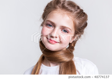 Appealing blonde young lady with wide smile Appealing blonde young lady with wide smile 48774137