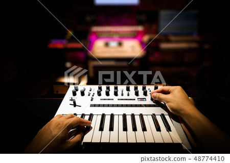 musician hands playing keyboard in home studio musician hands playing keyboard in home studio 48774410