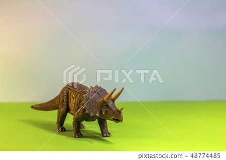 Toy dinosaur in a toy forest. like a real dino on a bright studio background with wooden trees. Eco Toy dinosaur in a toy forest. like a real dino on a bright studio background with wooden trees. Eco 48774485