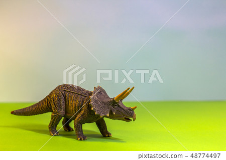 Toy dinosaur in a toy forest. like a real dino on a bright studio background with wooden trees. Eco Toy dinosaur in a toy forest. like a real dino on a bright studio background with wooden trees. Eco 48774497