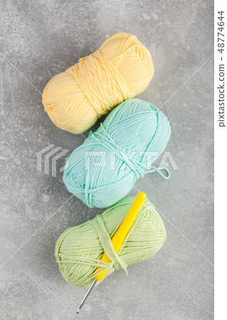 Colored skeins of yarn on dark background Colored skeins of yarn on dark background 48774644