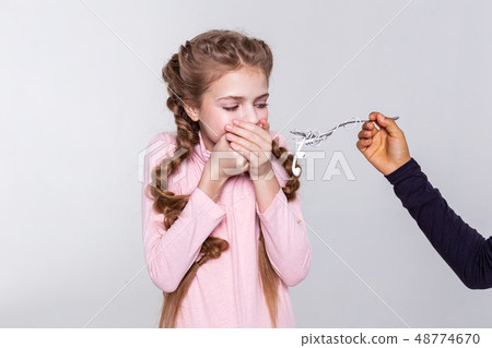 Blonde young girl being disgust with proposed meal Blonde young girl being disgust with proposed meal 48774670