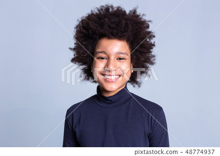 Pretty young boy with wide smile having African hairstyle Pretty young boy with wide smile having African hairstyle 48774937