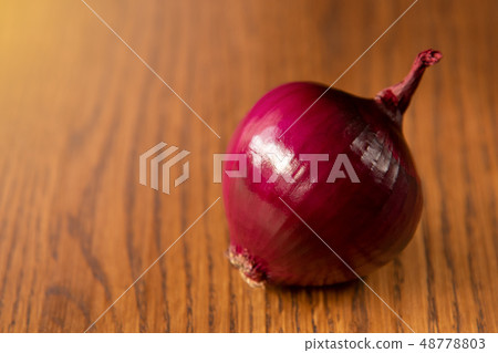 Fresh purple onion on dark wooden background. Fresh purple onion on dark wooden background. 48778803