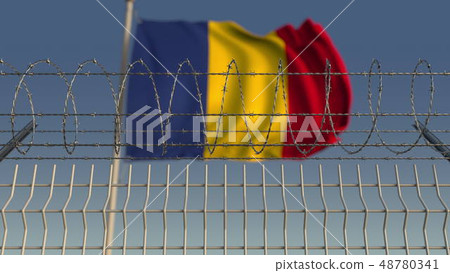 Defocused waving flag of Romania behind barbed wire fence. 3D rendering Defocused waving flag of Romania behind barbed wire fence. 3D rendering 48780341
