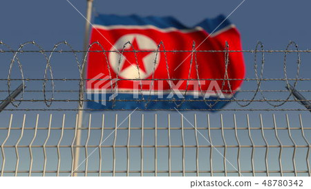 Barbed wire against waving flag of North Korea. 3D rendering 48780342