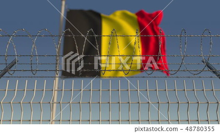 Barbed wire against waving flag of Belgium. 3D rendering Barbed wire against waving flag of Belgium. 3D rendering 48780355