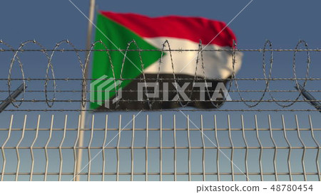 Defocused waving flag of Sudan behind barbed wire fence. 3D rendering 48780454
