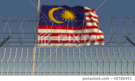 Barbed wire against waving flag of Malaysia. 3D rendering 48780491