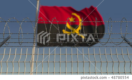 Blurred waving flag of Angola behind barbed wire fence. 3D rendering 48780554