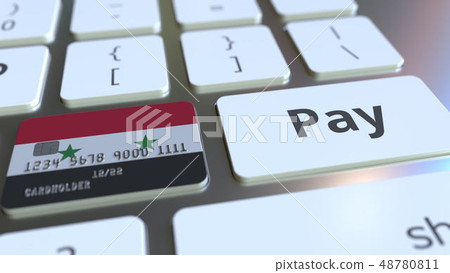 Bank card featuring flag of Syria as a key on a computer keyboard. Syrian online payment conceptual 48780811