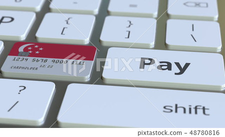Bank card featuring flag of Singapore as a key on a computer keyboard. Singaporean online payment 48780816