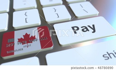 Bank card featuring flag of Canada as a key on a computer keyboard. Canadian online payment 48780890