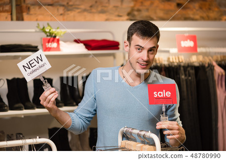 Young man with smiling white and red sign Young man with smiling white and red sign 48780990