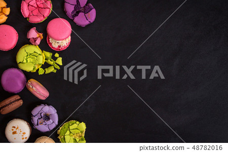 Assorted colorful macaroons on a dark background Assorted colorful macaroons on a dark background 48782016