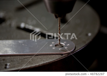 Drilling with a drilling machine Drilling with a drilling machine 48782287