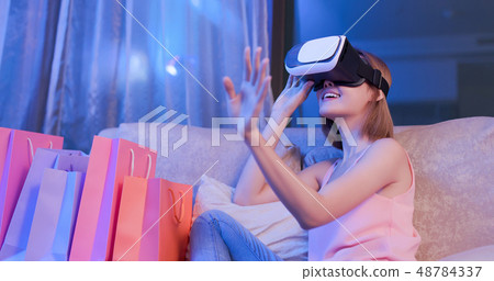 woman shopping with VR headset 48784337