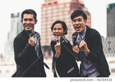 Businessmen and businesswoman celebrate success. 48784416