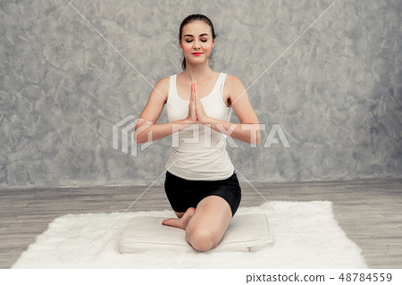 Young woman yoga on carpet at home living room. 48784559