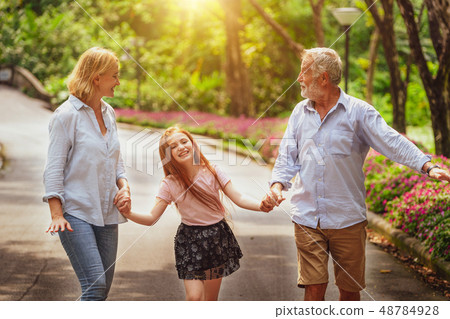 Happy healthy family walk together in the park. Happy healthy family walk together in the park. 48784928