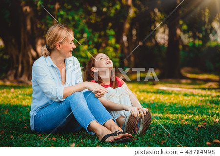 Happy mother and little kid daughter in park. Happy mother and little kid daughter in park. 48784998