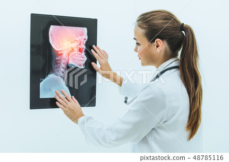 Doctor working with x ray film of patient head. 48785116