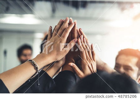 Many happy business people raise hands together. Many happy business people raise hands together. 48785206