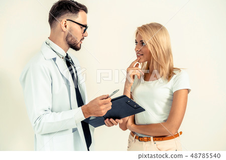 Male Doctor and Female Patient in Hospital Office 48785540