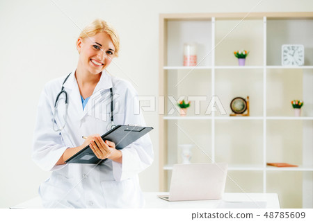 Young female doctor working in hospital office. Young female doctor working in hospital office. 48785609