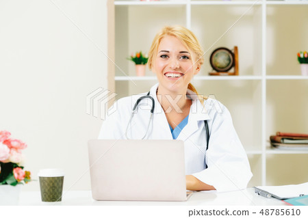Young female doctor working in hospital office. Young female doctor working in hospital office. 48785610