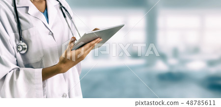 Doctor using tablet computer at the hospital. Doctor using tablet computer at the hospital. 48785611