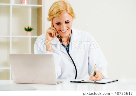 Young female doctor working in hospital office. Young female doctor working in hospital office. 48785612