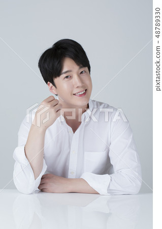 Portrait of attractive young man isolated on gray background 082 48789330